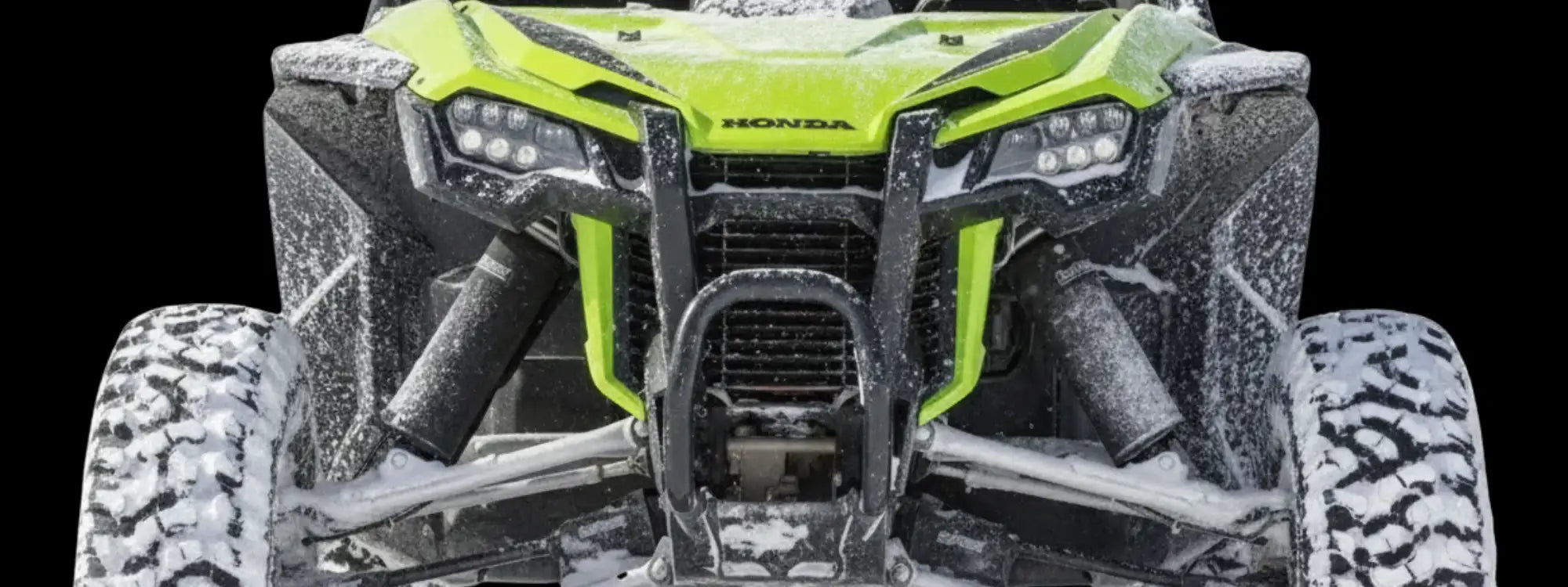 Neon yellow honda off-road vehicle with large rugged tires and protective front bumper.